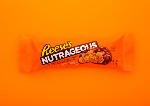 LONDON, UK - DECEMBER 30, 2024: Reese's peanut butter nutrageous snack bar on orange background.