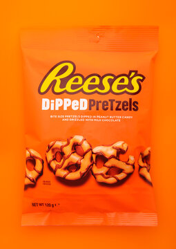 LONDON, UK - JANUARY 05, 2025: Reese's peanut butter dipped pretzels on orange background.