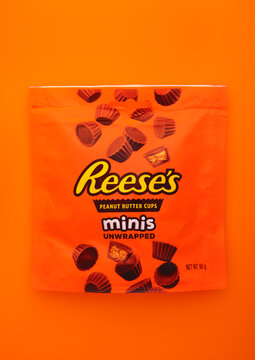 LONDON, UK - JANUARY 11, 2025: Reese's minis peanut butter chocolate cups on orange background.