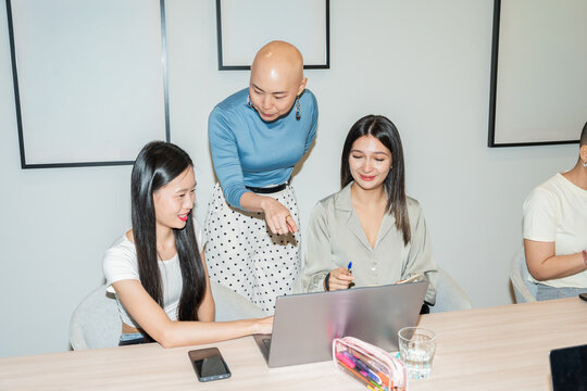 Candid Moment Of Women Discussing Work in a Meeting Room