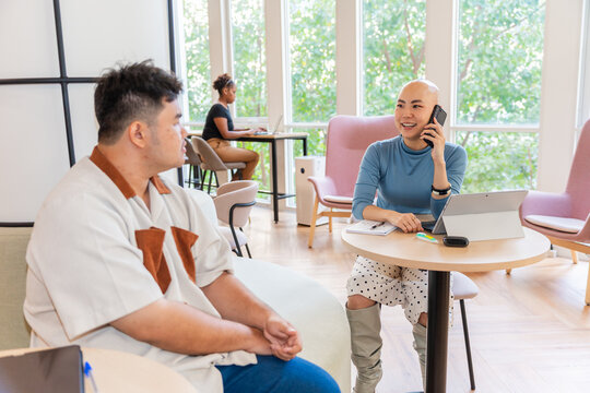 People Talk and Work in a Modern Office Space During the Day