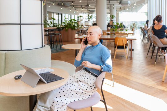 Woman Talking on Phone in Modern Workspace During Daytime