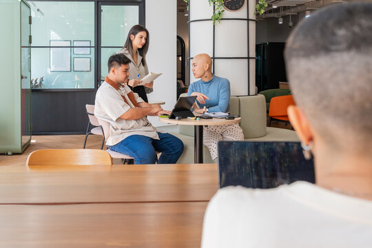 Group Meets for Discussion in an Office Setting During the Day