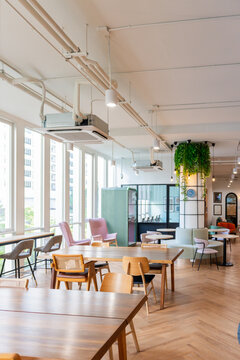 Coworking Interior With Tables and Chairs in a Bright Space.
