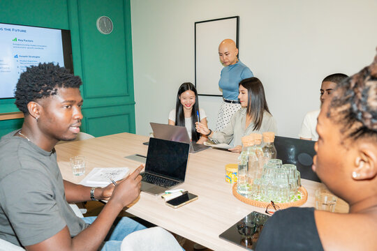 Group Meets to Discuss Plans in a Modern Office Setting