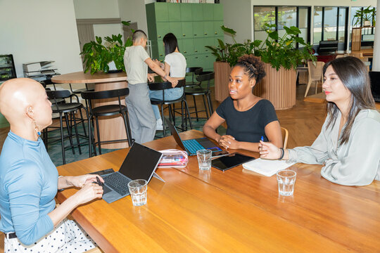 Discussion Among Three Colleagues in a Bright Indoor Office Setting
