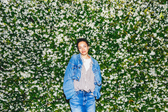 Woman in Front of Flowering Hedge