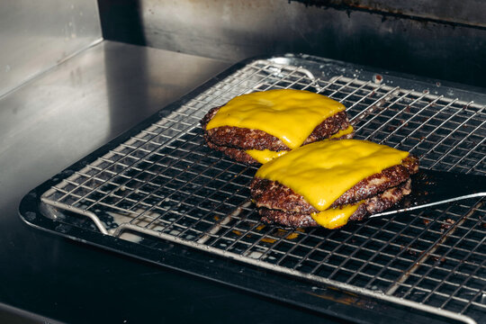 Direct flash cooking cheese burger. Fast food restaurant
