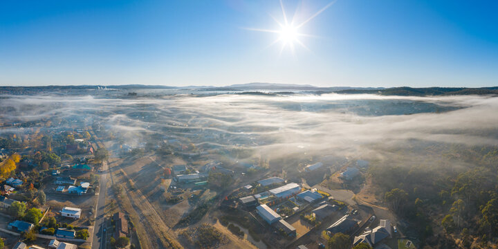 Layers of thin fog over a country town in early morning light