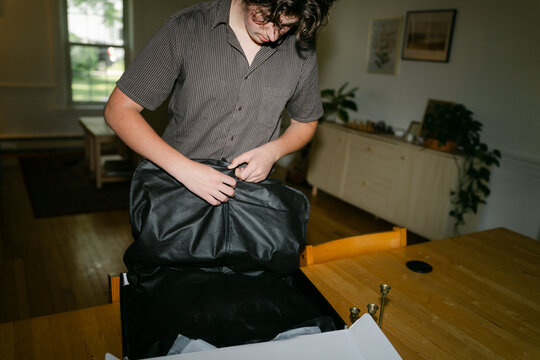 teen boy trying on a new suit 