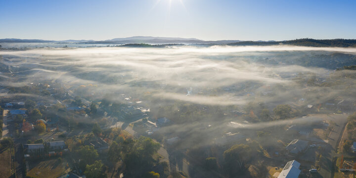 Layers of thin fog over a country town in early morning light