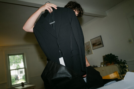 teen boy trying on a new suit 