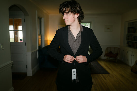 teen boy trying on a new suit 