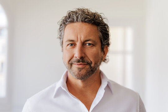 Grey haired businessman looking at camera