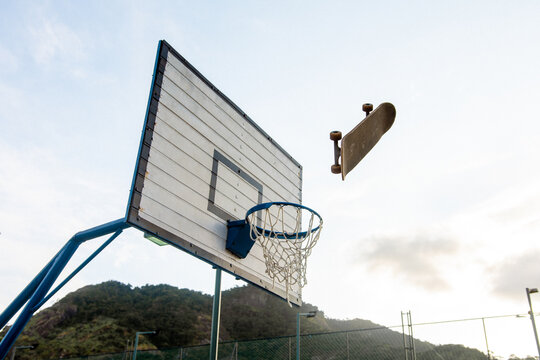 Skateboard Above Basketball Hoop