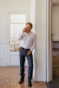 Professional man talking on phone at workspace