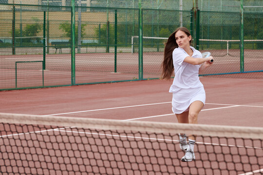 woman hitting the ball tennis