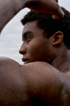 Man Showing Strength During Outdoor Workout at Sunrise