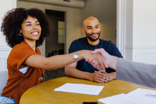 Couple shaking hands agreeing on business collaboration