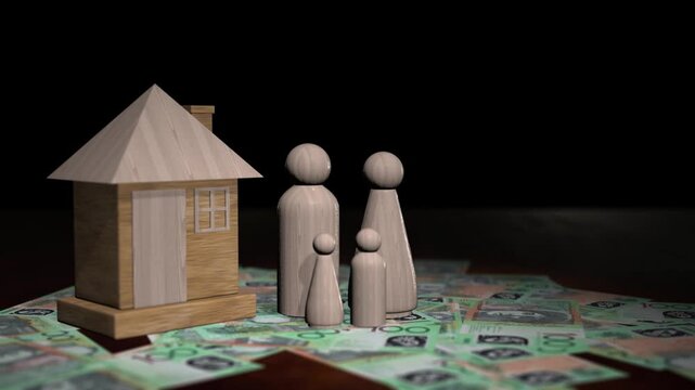 Rotating shot of wooden family figures and a house model on one hundred australian dollar banknotes.
