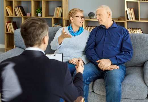 Psychologist therapy counseling session for seniors couple. Elderly partners talk as the professional listens, offering support to improve communication. Clear concept of counseling support.