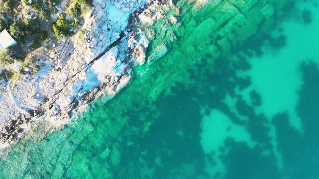Rocks above the ocean, Italy. Elba Island in Tuscany, aerial view. Slow motion