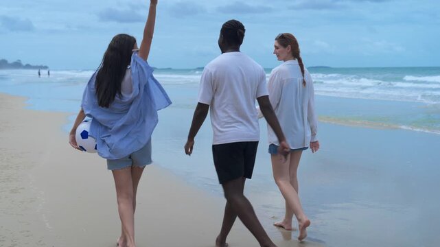 Friends enjoying the simple pleasures of a coastal holiday, walking in a relaxed line and fully embracing an unplugged weekend getaway.