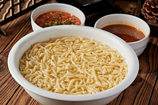 Thick pea flour soup served in a white porcelain bowl