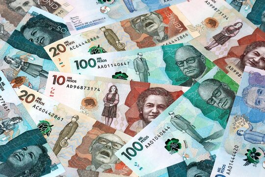 Colombian peso money bills in pile on table. Colombia COP currency cash close up