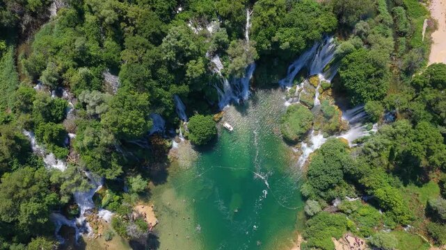 Kravica Waterfall, Bosnia and Herzegovina - June 7, 2026: Top down aerial view of visitors enjoying Kravica Waterfall