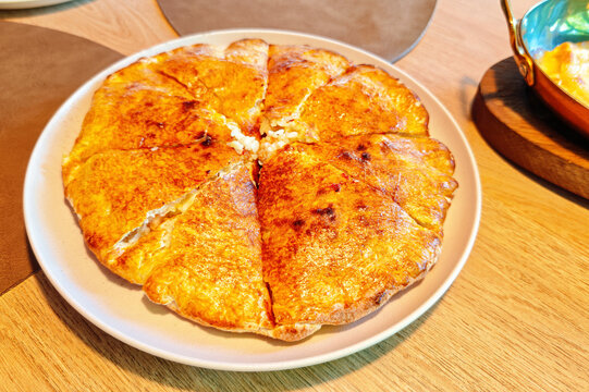 Khachapuri Megruli, a traditional Georgian bread with cheese inside and on top.
