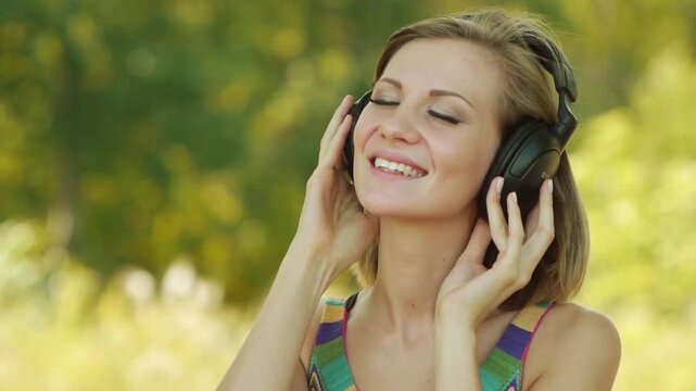 Young woman listening to music on headphones