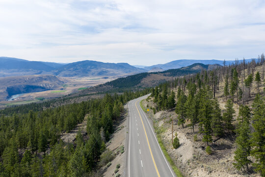 Scenic Highway Through Pine Forest and Mountains Overlooking Valley in British Columbia, Canada