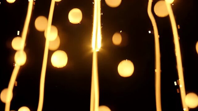 Warm glowing string lights with beautiful golden bokeh circles on a dark background for festive celebration