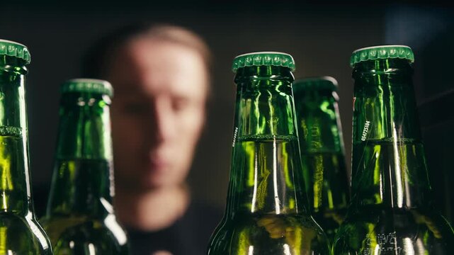 Row of beer bottles in fridge, shop or hotel, cold lager craft german beer or cider, shop supermarket or wine cooler close up.