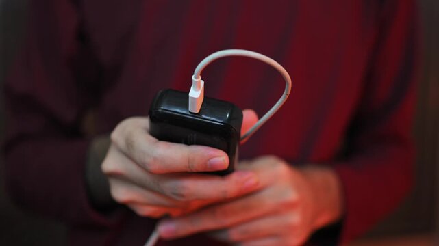 Close Up of Connecting USB Charging Cable to Power Adapter by Hand