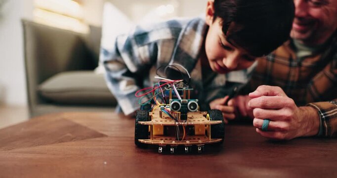 Dad, son and building with toy car in home for assembling parts, bonding or fun activity together. Father, child or helping boy on electrical motor vehicle for junior engineering or learning in house