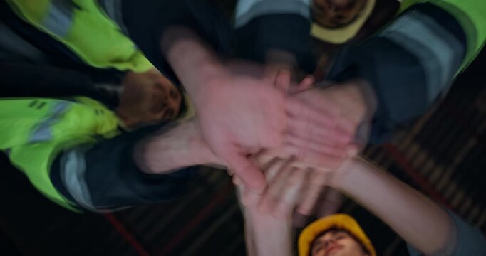 Contractor, people and applause with hands together in warehouse below for unity or mission. Low angle, architect team or group clapping with piling or stack for success or solidarity in workshop
