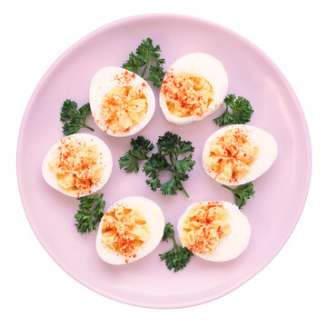 Plate of classic deviled eggs. Top view isolated on a white background.