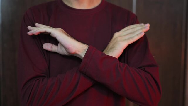 STOP hand gesture The guy shows a denial gesture with his hands. No, stop