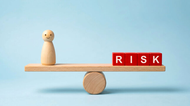 Balancing risk with wooden figure on seesaw