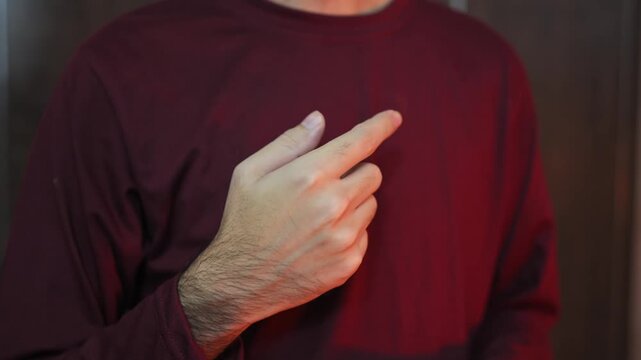 The man points his finger at himself and says I. Gesture with hands, a man points at himself with his fingers. A man points his finger at himself