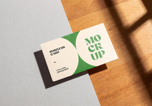 Business Card Mockup with Window Shadow on Wood and Paper Surface