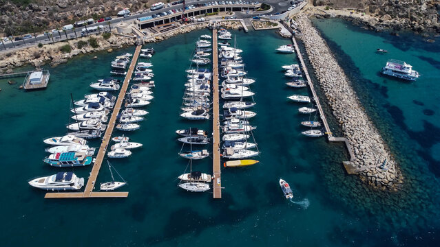 Drone view of boats mored in Mgarr harbour in Gozo Island, Malta.