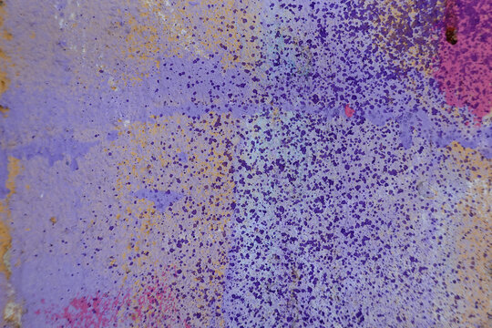 Urban graffiti wall texture with abstract spray paint lines in purple pink yellow tones