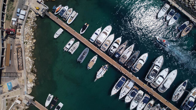 Drone view of boats mored in Mgarr harbour in Gozo Island, Malta.