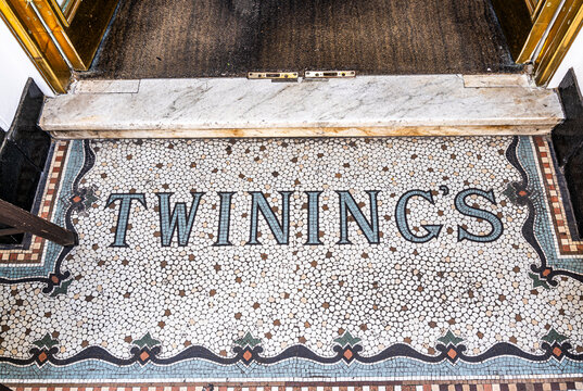 Twinings name inlaid as a mosaic in the entrance floor of the historic tea shop at 216 Strand, London, United Kingdom. The Twinings logo, is unchanged since 1787