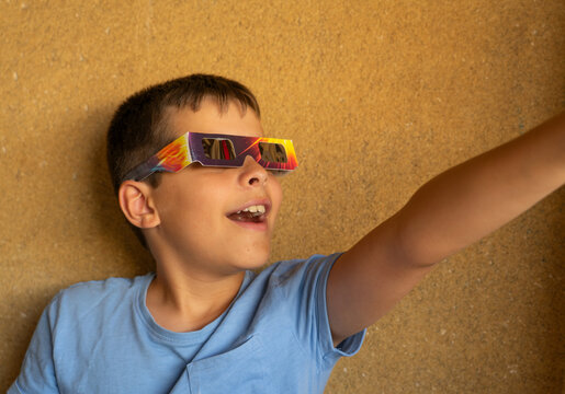 Excited boy wearing glasses to watch the magic of an eclipse