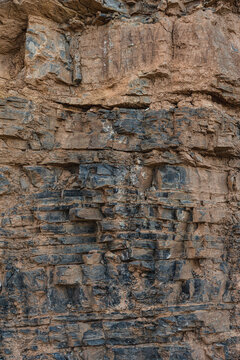 layers of various limestone rocks visible in the exposed mountainside