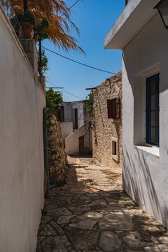a narrow street in the small Greek town of Margarites on the island of Crete